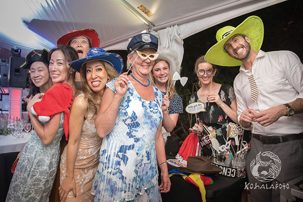 wedding guests wearing funny photo booth props