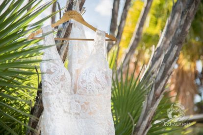 Bridal gown with custom hanger hanging on a tree