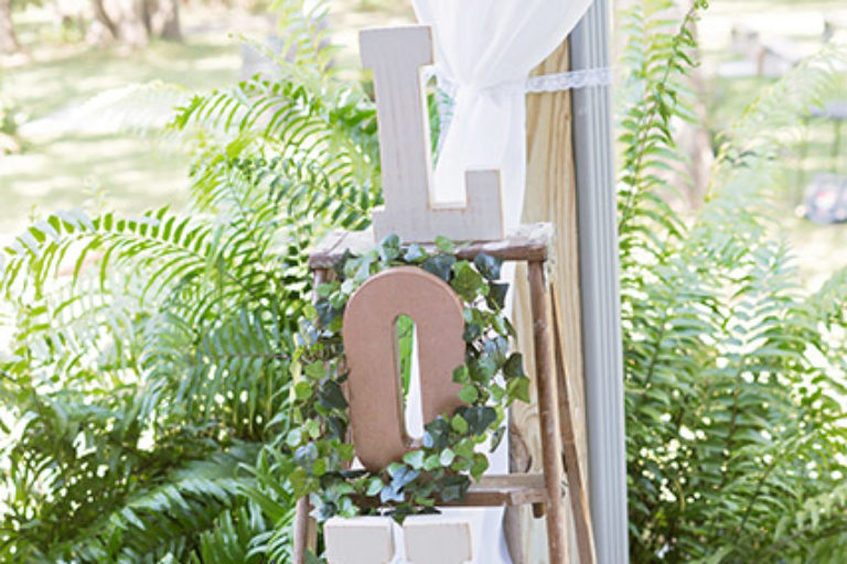 wooden letters spelling LOVE on a rustic ladder - wedding decor