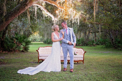 bride and groom outdoors in Arcadia, FL under a chandelier hanging from a tree