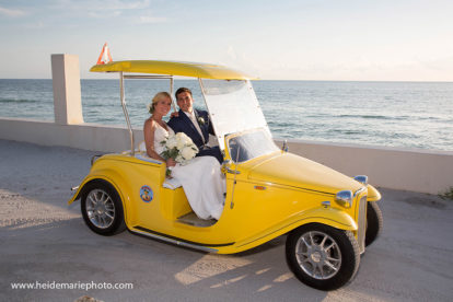 bride and groom driving a golf cart near the ocean on Boca Grande, Florida