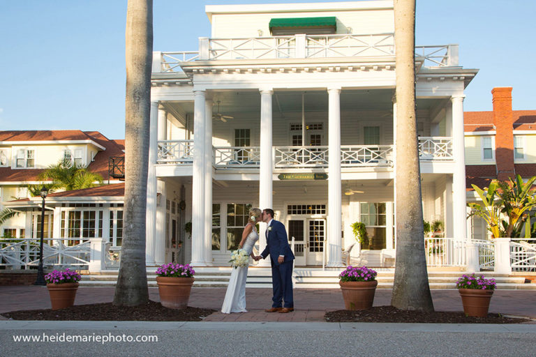 bride and groom kissing in front of the Gasparilla Inn in Boca Grande Florida