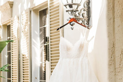 wedding dress hanging from an outdoor lantern