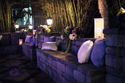 pillows and lanterns on an outdoor bench