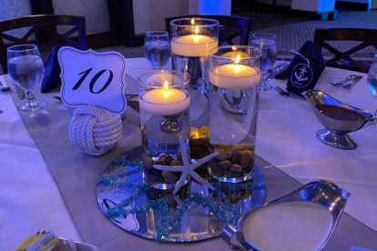 mirrored centerpiece with floating candles and sand dollars