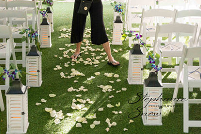 Wedding Planner Sheryl Ash decorating aisle with petals