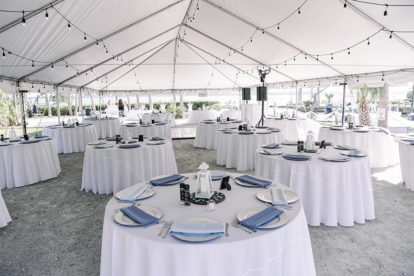 tables decorated for an outdoor wedding reception in a tent in Englewood FL