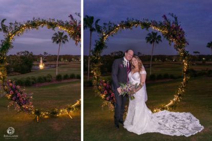 bride and groom standing beside an illuminated circular arbor at night