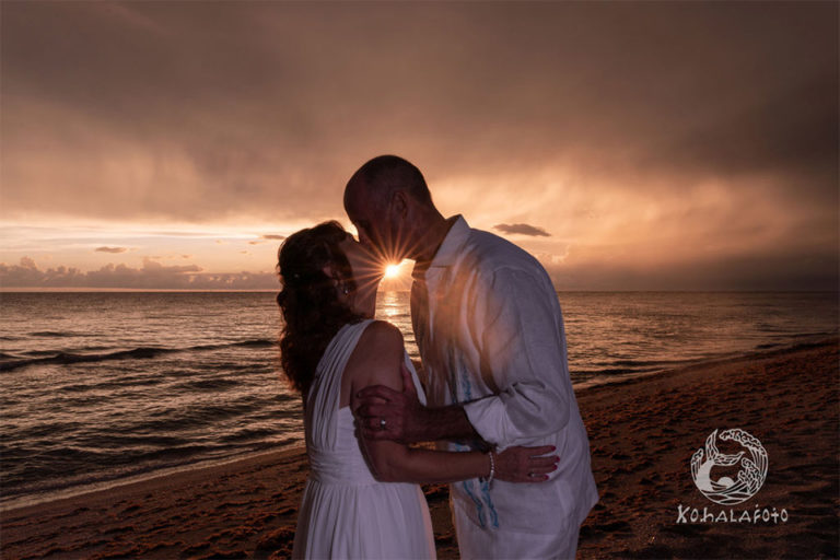 bride and groom kissing at sunset on a beach on Mansota Key, Englewood, FL