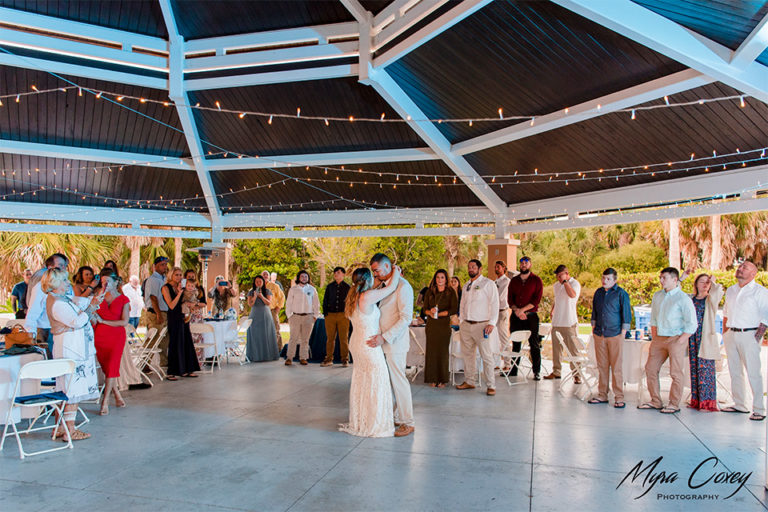 bride and groom dancing under lighted pavilion at outdoor wedding reception