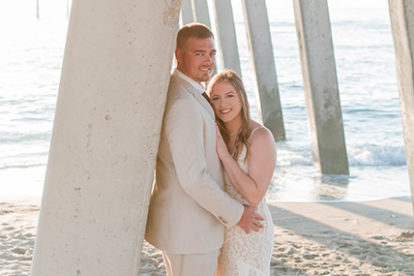 bride and groom standing under the Venice Fishing Pier
