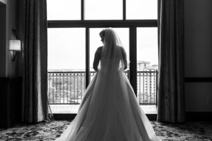 Bride gazing out the window of an Orlando Resort Hotel