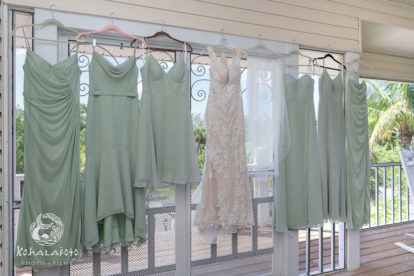 bridal gown and mint green bridesmaid dresses on hangers