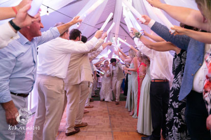 wedding guests creating a tunnel for bride and groom to run through