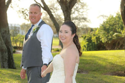bride and groom holding hands on a golf course