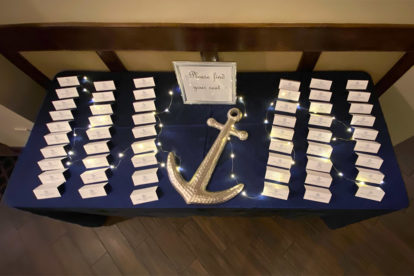 table with placecards, anchor and fairy lights