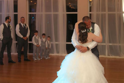first dance in a ballroom with beautiful draping and lights