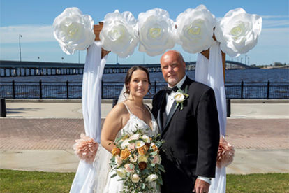 bride and groom with decorated arbor at outdoor wedding ceremony on Charlotte Harbor