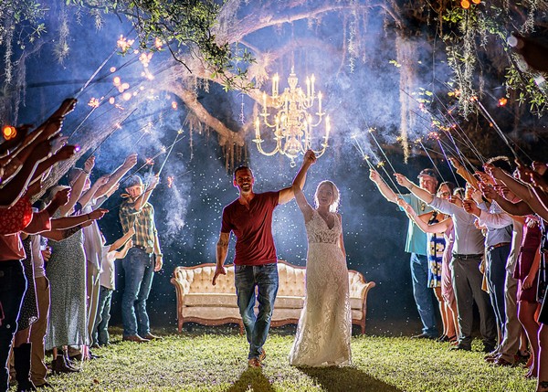 Rebecca's wedding in Arcadia - bride and groom walking through sparklers