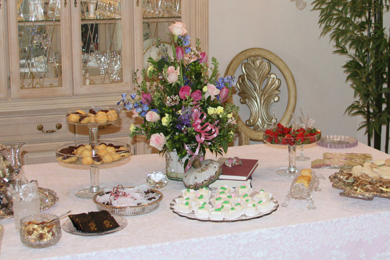 Birthday Party Planning and Design - dessert table with flower arrangements