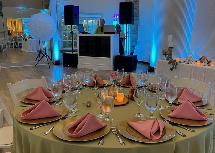 table setting and DJ booth setup at a wedding reception