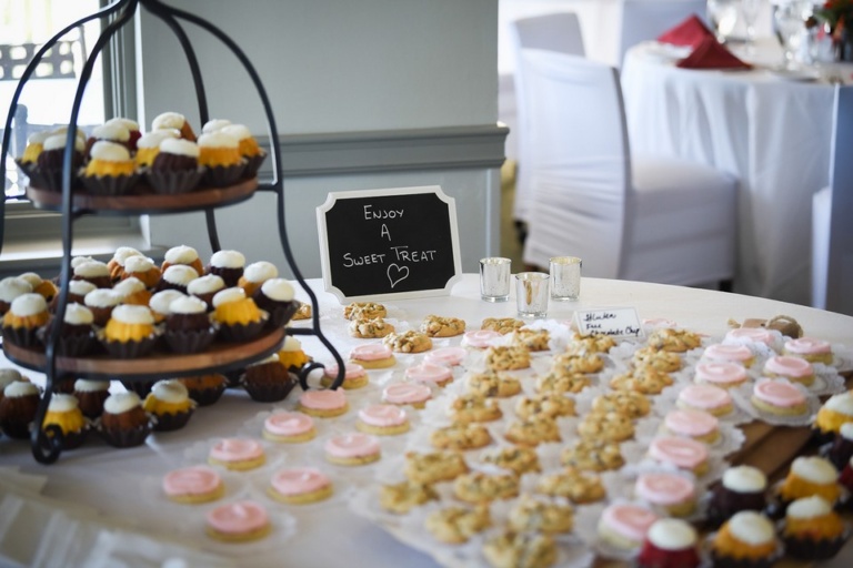 dessert table at a wedding reception with a chalkboard sign